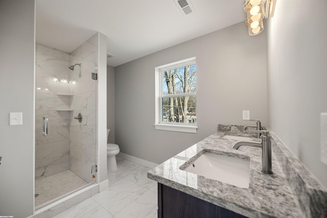 bathroom featuring visible vents, a shower stall, double vanity, marble finish floor, and a sink