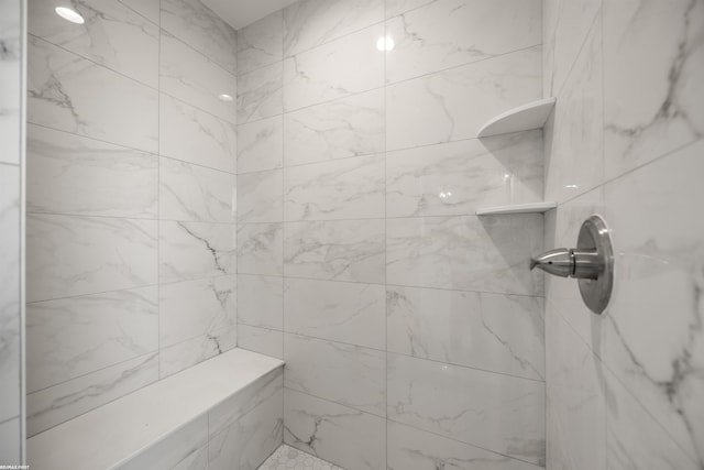 bathroom with a tile shower