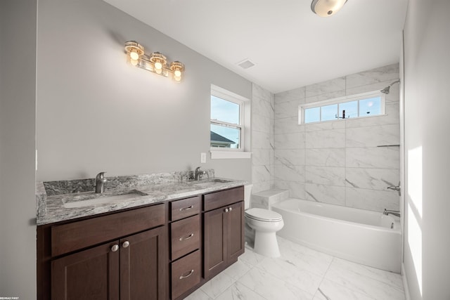 bathroom with a sink, toilet, marble finish floor, and shower / tub combination