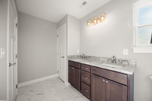 full bath with a sink, visible vents, baseboards, and marble finish floor