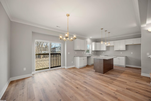 kitchen featuring a notable chandelier, baseboards, light wood-type flooring, and a center island