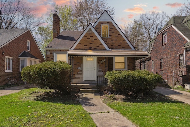 view of front of house with a porch, a front lawn, and a chimney