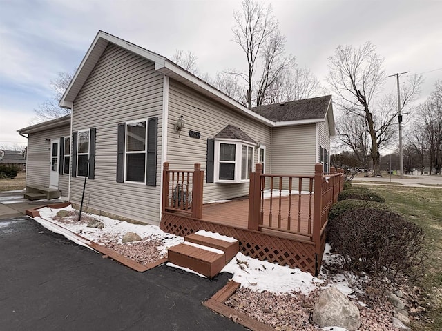 rear view of house featuring a deck