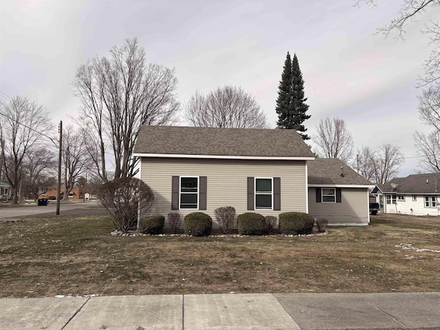 view of home's exterior featuring a yard and roof with shingles