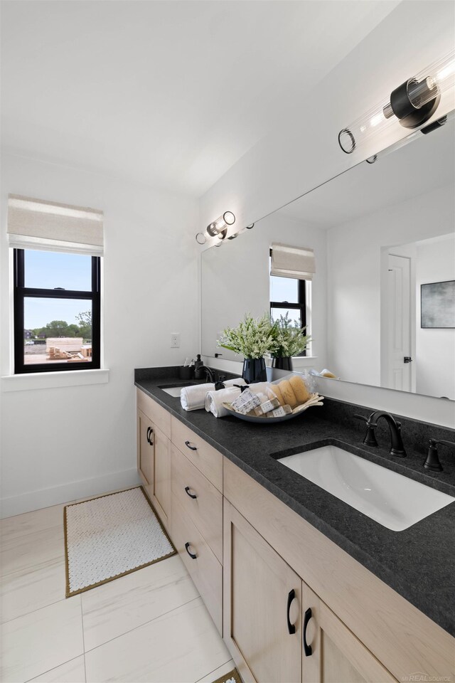 17447 Megan Dr, Macomb, MI 48042 - full bathroom with double vanity and baseboards