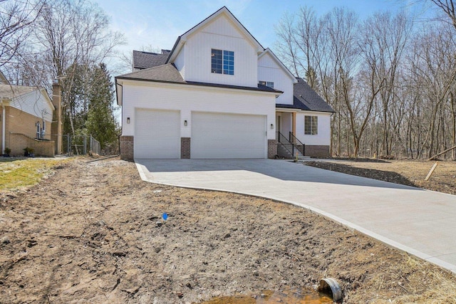 7474 Connies Dr, Shelby Twp, MI 48316 - view of front of house with concrete driveway, an attached garage, fence, and brick siding