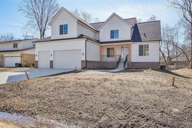 7474 Connies Dr, Shelby Twp, MI 48316 - view of front of home featuring central air condition unit, covered porch, concrete driveway, an attached garage, and brick siding