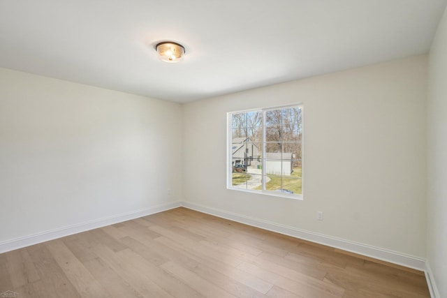 7474 Connies Dr, Shelby Twp, MI 48316 - spare room with light wood-style floors and baseboards