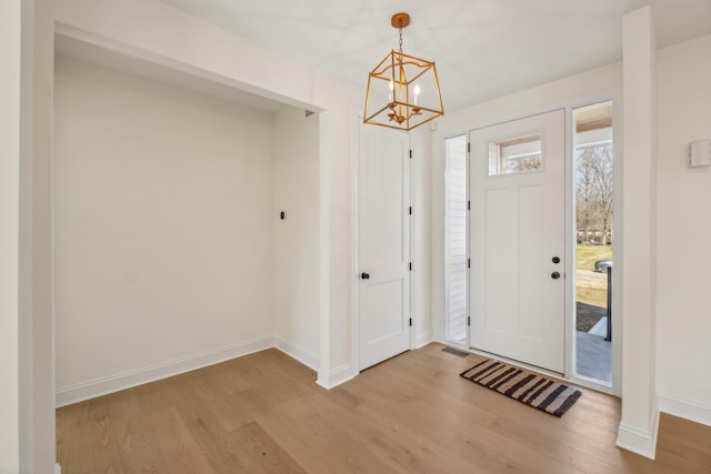 7474 Connies Dr, Shelby Twp, MI 48316 - entryway featuring visible vents, wood finished floors, baseboards, and a chandelier