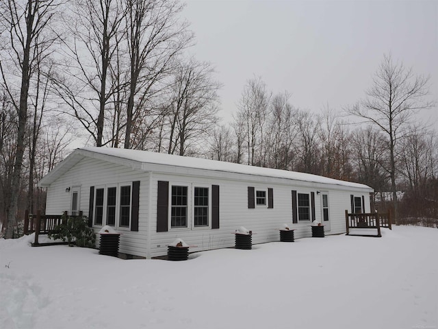view of front of house with cooling unit and a deck