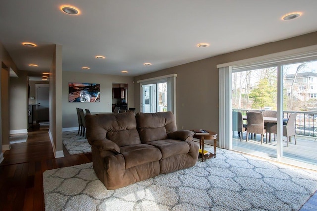 living area with recessed lighting, wood finished floors, and baseboards
