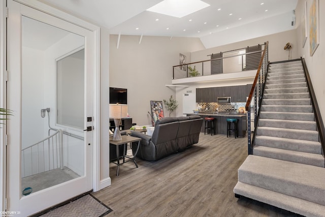65 Sea Ray Blvd Unit 7, Harrison Twp, MI 48045 - living area featuring recessed lighting, stairway, vaulted ceiling with skylight, and light wood-style flooring