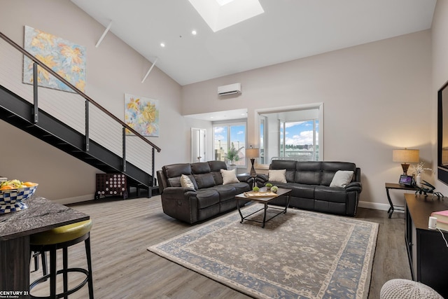 65 Sea Ray Blvd Unit 7, Harrison Twp, MI 48045 - living area with high vaulted ceiling, an AC wall unit, wood finished floors, a skylight, and stairs