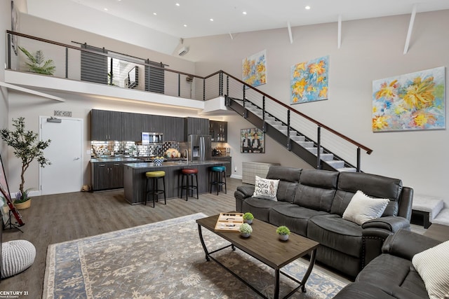 65 Sea Ray Blvd Unit 7, Harrison Twp, MI 48045 - living area featuring stairway, recessed lighting, light wood-type flooring, and a towering ceiling