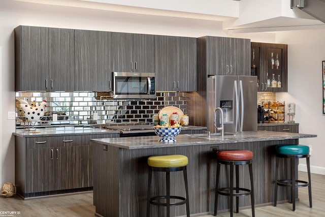 65 Sea Ray Blvd Unit 7, Harrison Twp, MI 48045 - kitchen featuring a sink, light wood-style floors, appliances with stainless steel finishes, and a breakfast bar area