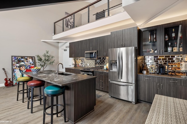 65 Sea Ray Blvd Unit 7, Harrison Twp, MI 48045 - kitchen with a breakfast bar, stainless steel appliances, light wood-style floors, and a sink