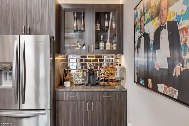65 Sea Ray Blvd Unit 7, Harrison Twp, MI 48045 - bar featuring tasteful backsplash, a bar, and stainless steel refrigerator with ice dispenser