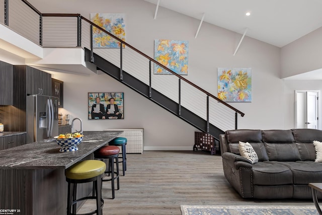 65 Sea Ray Blvd Unit 7, Harrison Twp, MI 48045 - living room featuring baseboards, high vaulted ceiling, light wood-style flooring, recessed lighting, and stairs