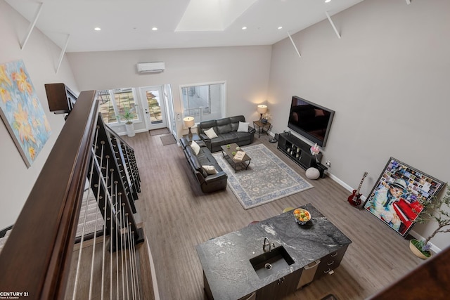 65 Sea Ray Blvd Unit 7, Harrison Twp, MI 48045 - living area featuring wood finished floors, baseboards, a wall mounted AC, a skylight, and recessed lighting