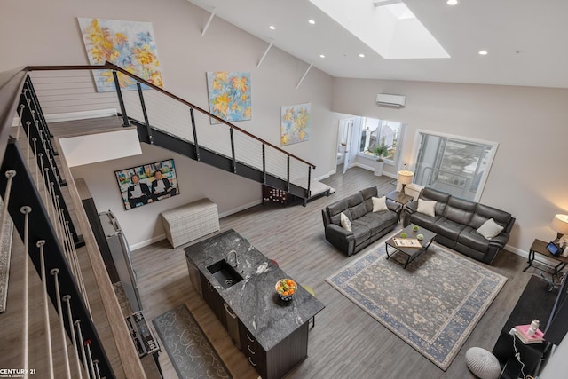 65 Sea Ray Blvd Unit 7, Harrison Twp, MI 48045 - living room featuring wood finished floors, baseboards, high vaulted ceiling, a skylight, and stairs