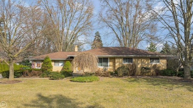 ranch-style house with brick siding and a front lawn