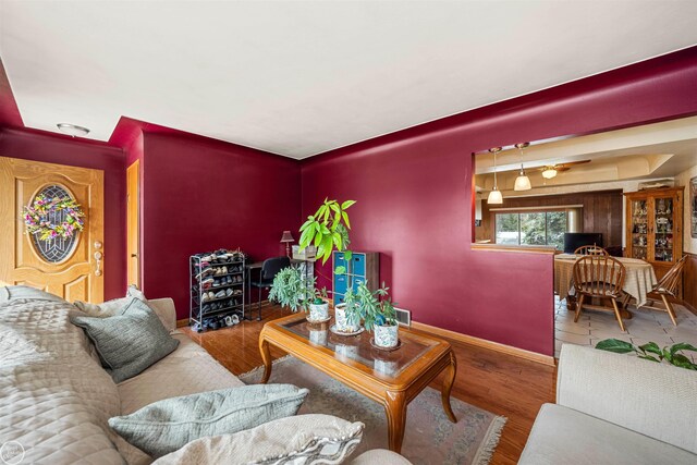living area featuring baseboards and wood finished floors