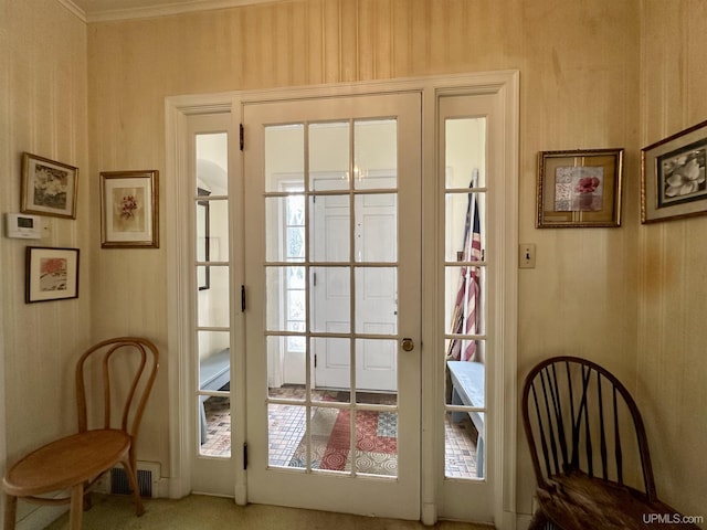 doorway to outside with wallpapered walls, visible vents, and french doors