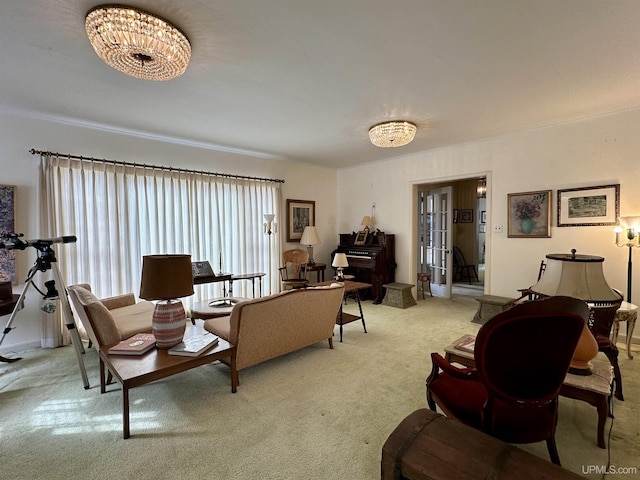 living room with a notable chandelier and light carpet