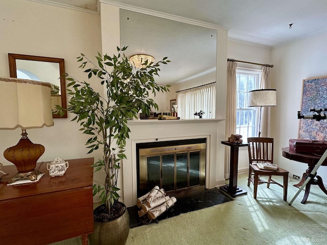 living area with a fireplace with flush hearth and crown molding