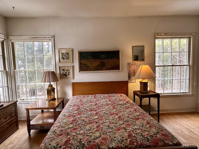bedroom featuring baseboards and wood finished floors