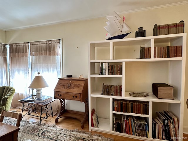 sitting room featuring wood finished floors and crown molding
