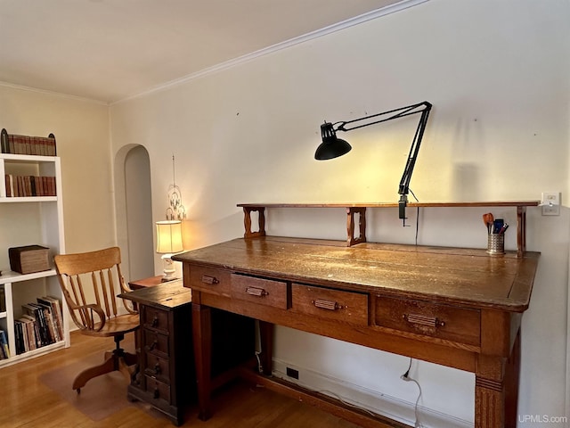 office space with dark wood-style floors, crown molding, and arched walkways