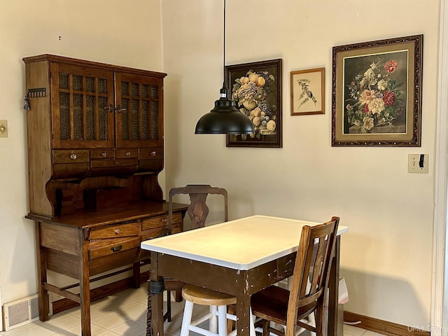dining room with baseboards and visible vents