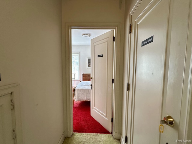hall featuring light carpet