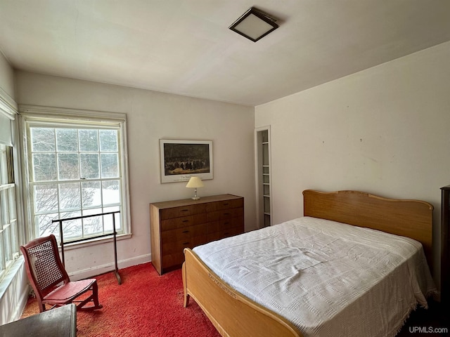 bedroom with carpet flooring and baseboards