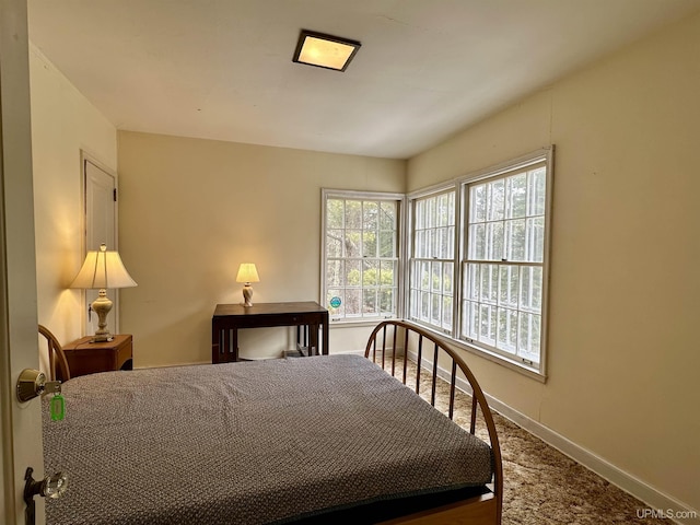 carpeted bedroom with baseboards