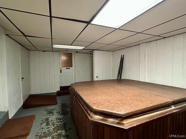 finished below grade area featuring a paneled ceiling