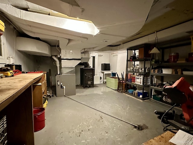 unfinished basement featuring heating unit and a workshop area