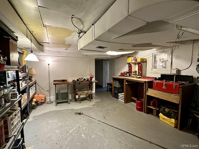 unfinished below grade area featuring a workshop area