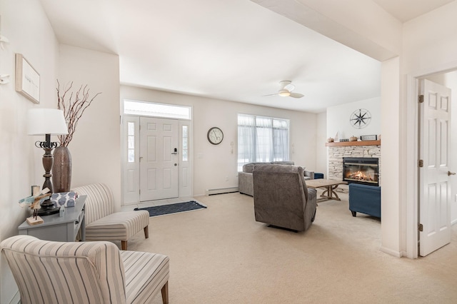 102 Phoxy Ln, Indian River, MI 49749 - living area with a fireplace, ceiling fan, baseboard heating, and light carpet