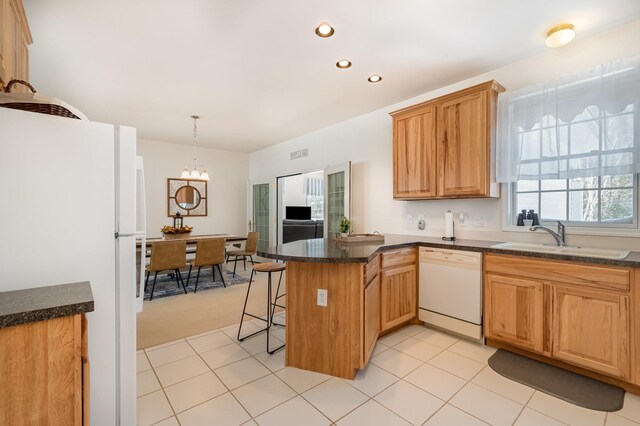 102 Phoxy Ln, Indian River, MI 49749 - kitchen with a breakfast bar area, white appliances, a sink, a peninsula, and a notable chandelier