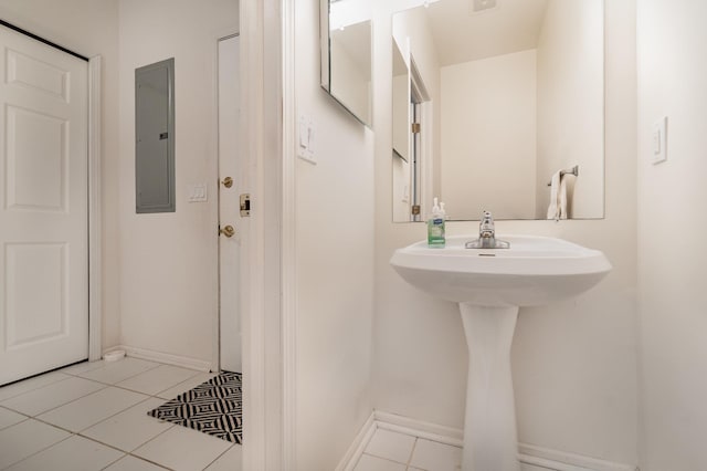102 Phoxy Ln, Indian River, MI 49749 - bathroom with tile patterned flooring, a sink, baseboards, and electric panel