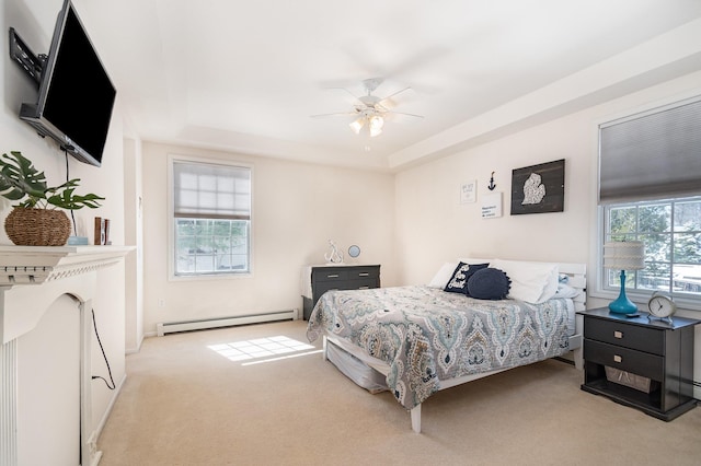 102 Phoxy Ln, Indian River, MI 49749 - carpeted bedroom featuring a tray ceiling, a ceiling fan, and a baseboard radiator