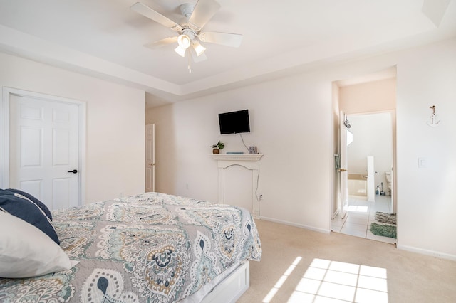 102 Phoxy Ln, Indian River, MI 49749 - bedroom with light carpet, baseboards, connected bathroom, and a raised ceiling