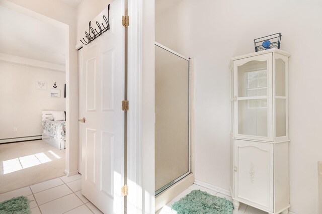 102 Phoxy Ln, Indian River, MI 49749 - interior space featuring tile patterned floors, a baseboard heating unit, and a shower stall