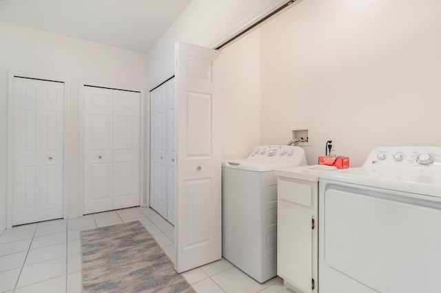 102 Phoxy Ln, Indian River, MI 49749 - laundry room featuring washing machine and clothes dryer, light tile patterned flooring, and laundry area