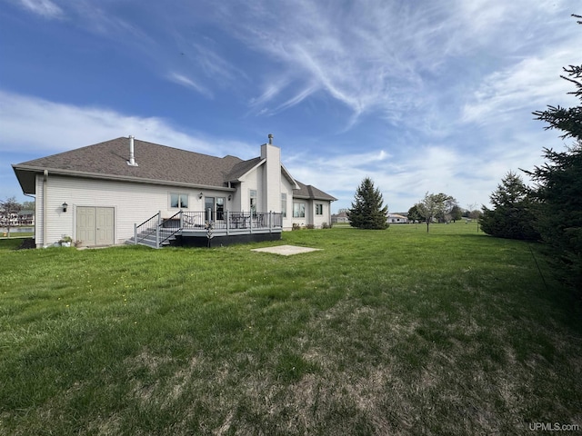 2111 Jordan Dr, Marinette C-Wi, WI 54143 - rear view of house with a deck, a lawn, and a chimney