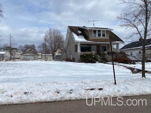 snow covered property featuring covered porch