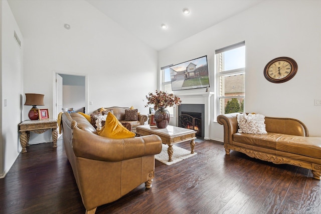living room featuring a fireplace with flush hearth, high vaulted ceiling, visible vents, recessed lighting, and hardwood / wood-style floors
