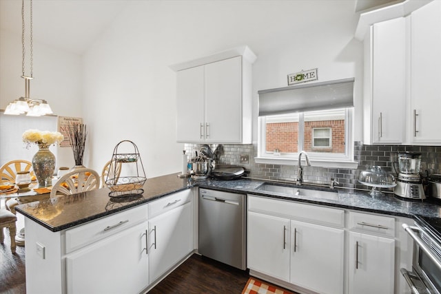 kitchen with a sink, stainless steel appliances, a peninsula, and decorative backsplash